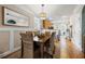 Open dining room with views into the kitchen and entry, and a large mirror adding depth to the space at 240 Daisy Cir, Mcdonough, GA 30252