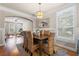 Bright dining room with stylish lighting fixture and large window for plenty of natural light at 240 Daisy Cir, Mcdonough, GA 30252