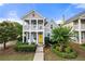 Charming two-story home featuring a welcoming porch, a bright yellow door, and manicured landscaping at 240 Daisy Cir, Mcdonough, GA 30252