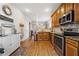 Well-lit kitchen featuring stainless steel appliances, granite countertops, and wood flooring at 240 Daisy Cir, Mcdonough, GA 30252