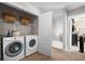 Functional laundry room featuring a modern washer and dryer, with open doorway, providing convenience for everyday chores at 240 Daisy Cir, Mcdonough, GA 30252