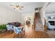 Cozy living room featuring a staircase, fireplace, hardwood floors, and archway leading to the dining area at 240 Daisy Cir, Mcdonough, GA 30252