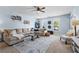 Spacious living room with light blue walls, a large sectional sofa, and bright, natural light at 240 Daisy Cir, Mcdonough, GA 30252