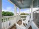 Inviting covered porch featuring a ceiling fan, white rocking chairs, and a view of the street at 240 Daisy Cir, Mcdonough, GA 30252