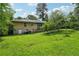 A large backyard with green grass surrounds the house, providing a peaceful outdoor space at 2880 Shallowford Rd, Chamblee, GA 30341