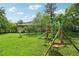 Spacious backyard featuring a playground, grassy lawn, and mature trees, perfect for outdoor activities and relaxation at 2880 Shallowford Rd, Chamblee, GA 30341