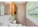 Cozy bathroom features a classic vanity, toilet, and a window at 2880 Shallowford Rd, Chamblee, GA 30341