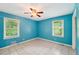 Serene bedroom featuring blue walls, tile floors, and a bright window view at 2880 Shallowford Rd, Chamblee, GA 30341
