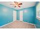 Bright bedroom features a ceiling fan, tile floors, and two access doors at 2880 Shallowford Rd, Chamblee, GA 30341