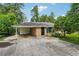 Charming single-story brick home with a covered carport and lush, mature landscaping creating curb appeal at 2880 Shallowford Rd, Chamblee, GA 30341