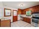 Bright kitchen showcasing wood cabinets, stainless steel appliances, and tiled flooring at 2880 Shallowford Rd, Chamblee, GA 30341