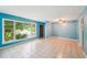 Open living room featuring large windows, tile flooring, and easy access to the kitchen and other rooms at 2880 Shallowford Rd, Chamblee, GA 30341