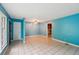Spacious living room with neutral tile flooring, a ceiling fan, and doorways to other rooms at 2880 Shallowford Rd, Chamblee, GA 30341