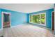 Cozy living room with tile floors, large windows offering garden views, and access to various rooms at 2880 Shallowford Rd, Chamblee, GA 30341