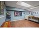 Finished basement area with wood flooring, bar seating, sofa and sports decor at 9470 Hillside Dr, Roswell, GA 30076