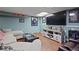 Finished basement area featuring a sofa, console, large TV and sports decor at 9470 Hillside Dr, Roswell, GA 30076