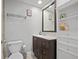 Modern bathroom featuring a vanity with granite countertop, a toilet, and stylish storage at 9470 Hillside Dr, Roswell, GA 30076
