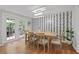 Dining room with hardwood floors and modern wallpaper at 9470 Hillside Dr, Roswell, GA 30076
