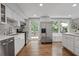 Modern kitchen with stainless steel appliances, quartz countertop and hardwood floors at 9470 Hillside Dr, Roswell, GA 30076