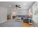 Cozy living room with hardwood floors, neutral paint, and a large blue sectional at 9470 Hillside Dr, Roswell, GA 30076