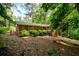 Back exterior of home with brick facade and many windows surrounded by mature shade trees at 2518 Foster Ridge Ne Ct, Atlanta, GA 30345