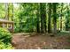 Backyard featuring mature trees, and wooded surroundings, and exterior of the home at 2518 Foster Ridge Ne Ct, Atlanta, GA 30345