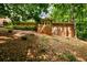 Back exterior of home with brick facade and many windows surrounded by mature shade trees at 2518 Foster Ridge Ne Ct, Atlanta, GA 30345