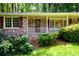 Brick home showcasing a charming front porch and well-manicured landscaping at 2518 Foster Ridge Ne Ct, Atlanta, GA 30345