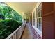 Covered front porch featuring brick accents and a white railing overlooking the lush greenery at 2518 Foster Ridge Ne Ct, Atlanta, GA 30345