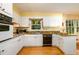 Bright eat-in kitchen features white cabinets, granite countertops, and hardwood floors, perfect for cooking at 2518 Foster Ridge Ne Ct, Atlanta, GA 30345
