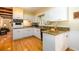 Well-lit kitchen with white cabinetry, granite countertops, and hardwood floors opens to the living area at 2518 Foster Ridge Ne Ct, Atlanta, GA 30345