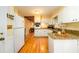 Charming kitchen with white cabinets, granite countertops, and hardwood floors offers a welcoming space at 2518 Foster Ridge Ne Ct, Atlanta, GA 30345