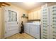 Laundry room with flower cabinet, vinyl floors, washer, dryer and exterior access at 2518 Foster Ridge Ne Ct, Atlanta, GA 30345