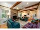 Inviting living room features a brick fireplace, hardwood floors, and beamed ceilings at 2518 Foster Ridge Ne Ct, Atlanta, GA 30345