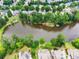 Scenic aerial view of homes surrounding a serene lake, showcasing the neighborhood's lush greenery and waterfront properties at 4526 Meadow Club Dr, Suwanee, GA 30024