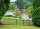 Serene lake view from the fenced backyard offering tranquility and picturesque scenery at 4526 Meadow Club Dr, Suwanee, GA 30024