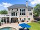 Expansive backyard featuring a pristine pool, lush lawn, and a covered patio for outdoor relaxation and entertainment at 4526 Meadow Club Dr, Suwanee, GA 30024