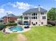 Stunning backyard with a luxurious pool, well-manicured lawn, and spacious outdoor area perfect for entertaining at 4526 Meadow Club Dr, Suwanee, GA 30024