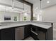 Entertain in this stylish wet bar with sleek black cabinetry and modern stainless steel appliances at 4526 Meadow Club Dr, Suwanee, GA 30024