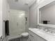 Well-lit bathroom with glass shower, marble counter, and vanity at 4526 Meadow Club Dr, Suwanee, GA 30024