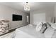 Bedroom with gray bedding and wood floors includes a flat screen TV and double closet at 4526 Meadow Club Dr, Suwanee, GA 30024