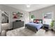 This is a bedroom featuring stylish gray furniture, decor and a gray accent wall with three shelves at 4526 Meadow Club Dr, Suwanee, GA 30024