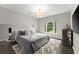 Bedroom with gray bedding, wood floors and a large window with great natural light at 4526 Meadow Club Dr, Suwanee, GA 30024