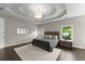 Comfortable bedroom with tray ceilings, recessed lighting, and large window views at 4526 Meadow Club Dr, Suwanee, GA 30024