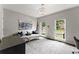Bright bedroom with a comfortable daybed, modern decor, and large windows offering natural light at 4526 Meadow Club Dr, Suwanee, GA 30024