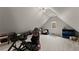 This is a bonus room with a light carpet, window and storage at 4526 Meadow Club Dr, Suwanee, GA 30024