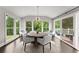 Inviting dining room with a round table, surrounded by large windows and lush outdoor views at 4526 Meadow Club Dr, Suwanee, GA 30024
