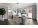 Dining area with modern chandelier, hardwood floors, and neutral walls with plenty of natural light at 4526 Meadow Club Dr, Suwanee, GA 30024