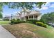 Lovely two-story home with a well-maintained lawn, lush green shrubs, and inviting curb appeal at 4526 Meadow Club Dr, Suwanee, GA 30024