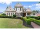 Charming two-story home with manicured lawn, brick walkway, and inviting front porch at 4526 Meadow Club Dr, Suwanee, GA 30024